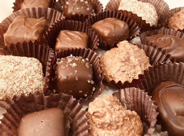 Samples of different chocolates covered in nuts and salt